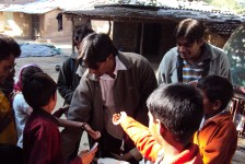 Anil distributing stationery with Jimit